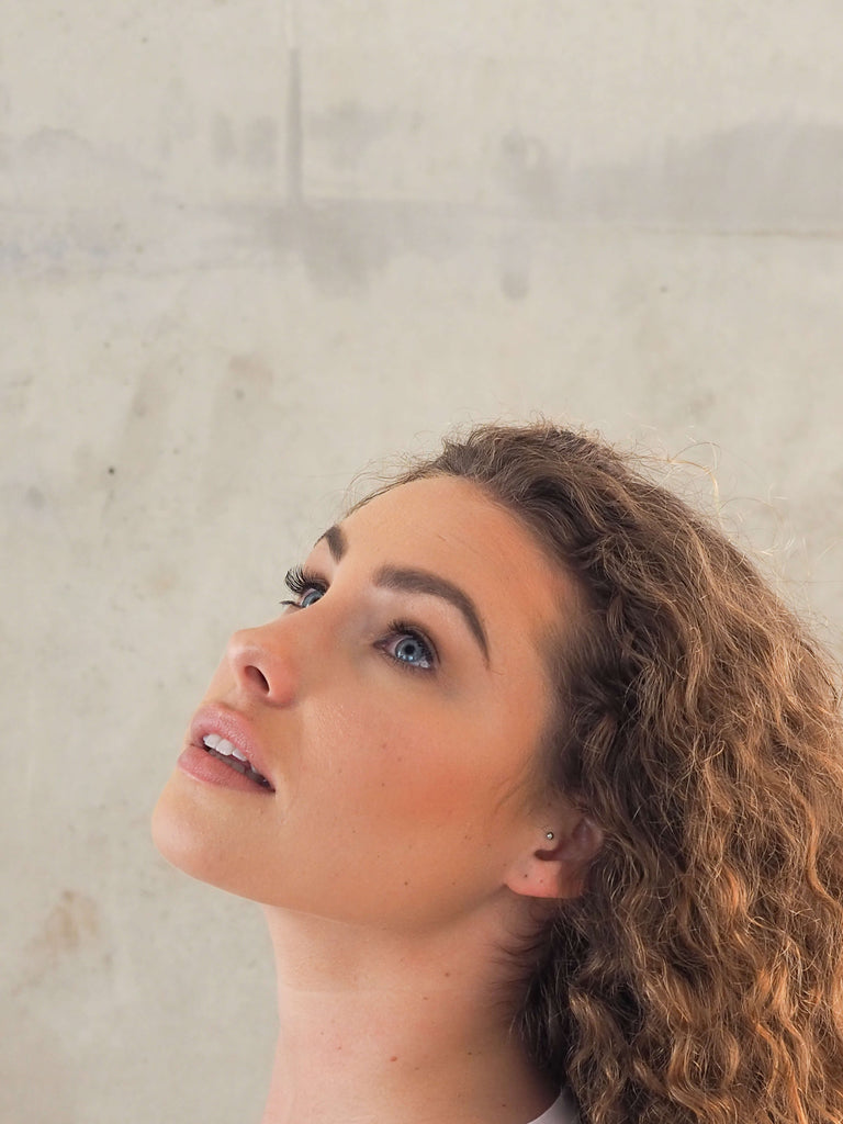 Model Looking Up with Curly Brown Hair