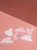 The Unnamed Rose Quartz Gua Sha Massage Tools on Pink Background